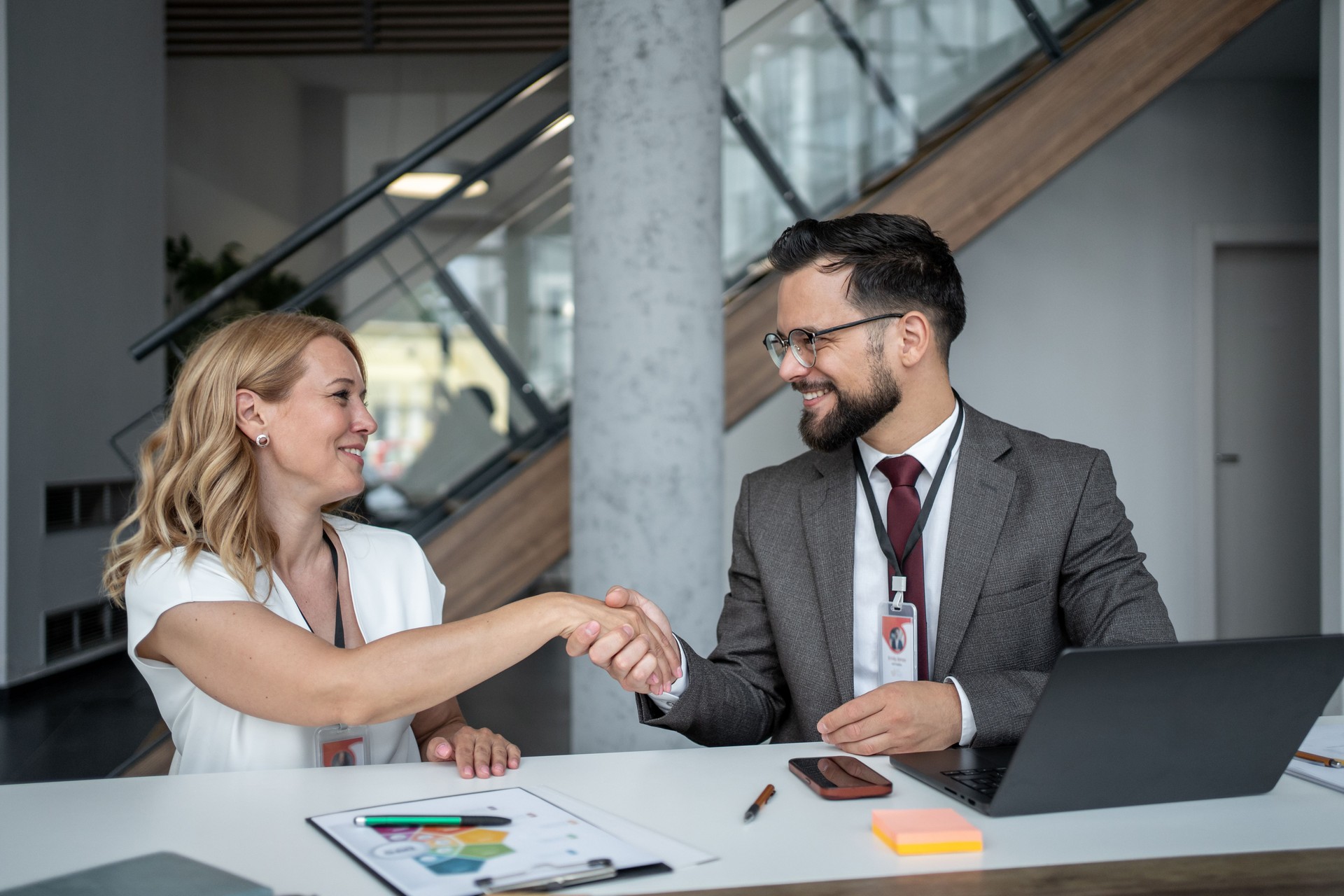 Business people shaking hands after successful meeting in office